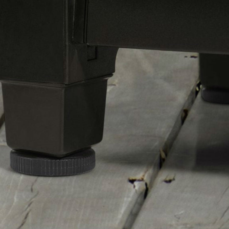 Close-up of a black metal leg on a wooden floor