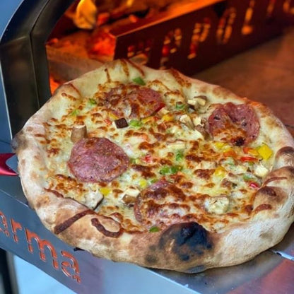 Pizza being cooked in a wood-fired oven with 'Wppco' branding.