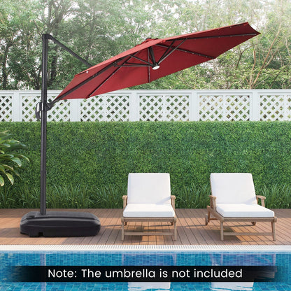 Red outdoor umbrella on a stand next to two lounge chairs by a pool with greenery in the background.