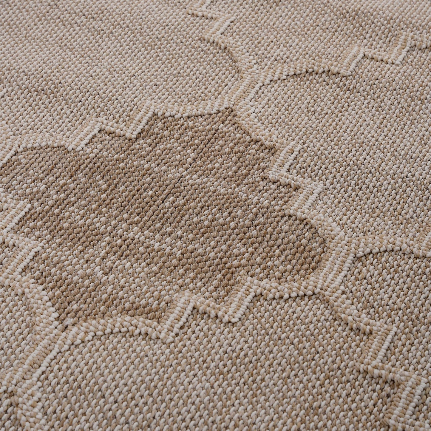 Close-up of a textured beige fabric with a subtle pattern