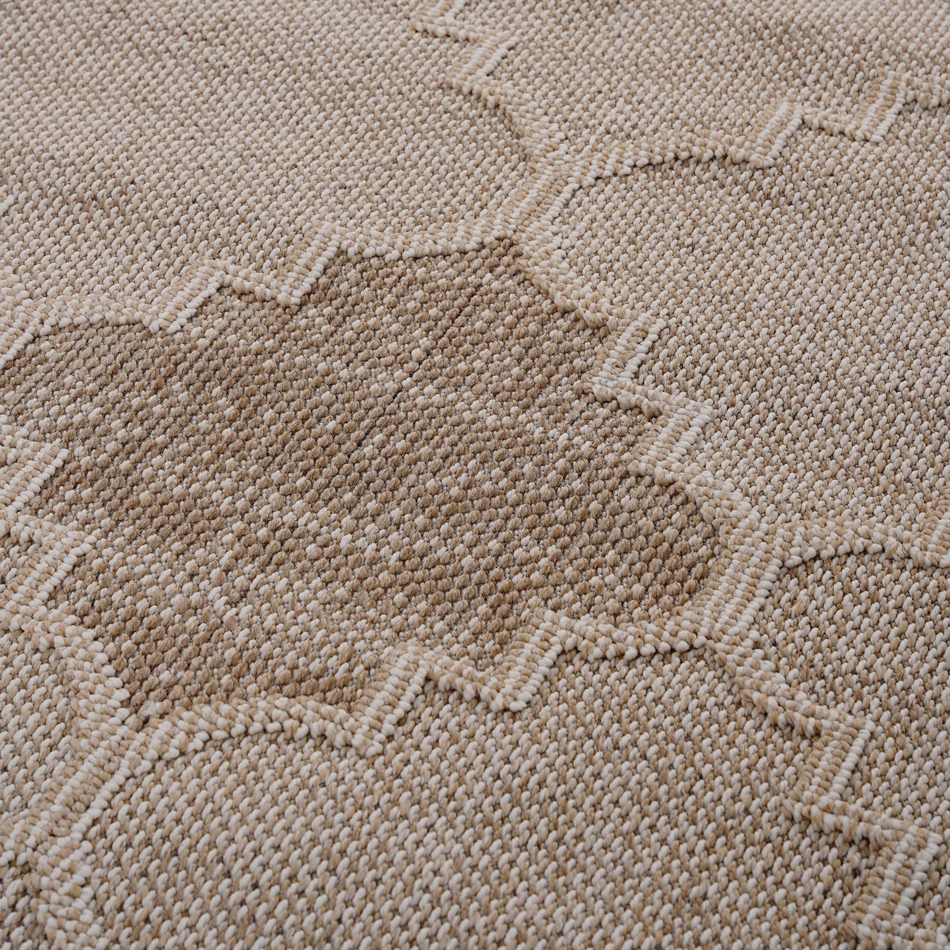 Close-up of a textured beige fabric with a subtle pattern