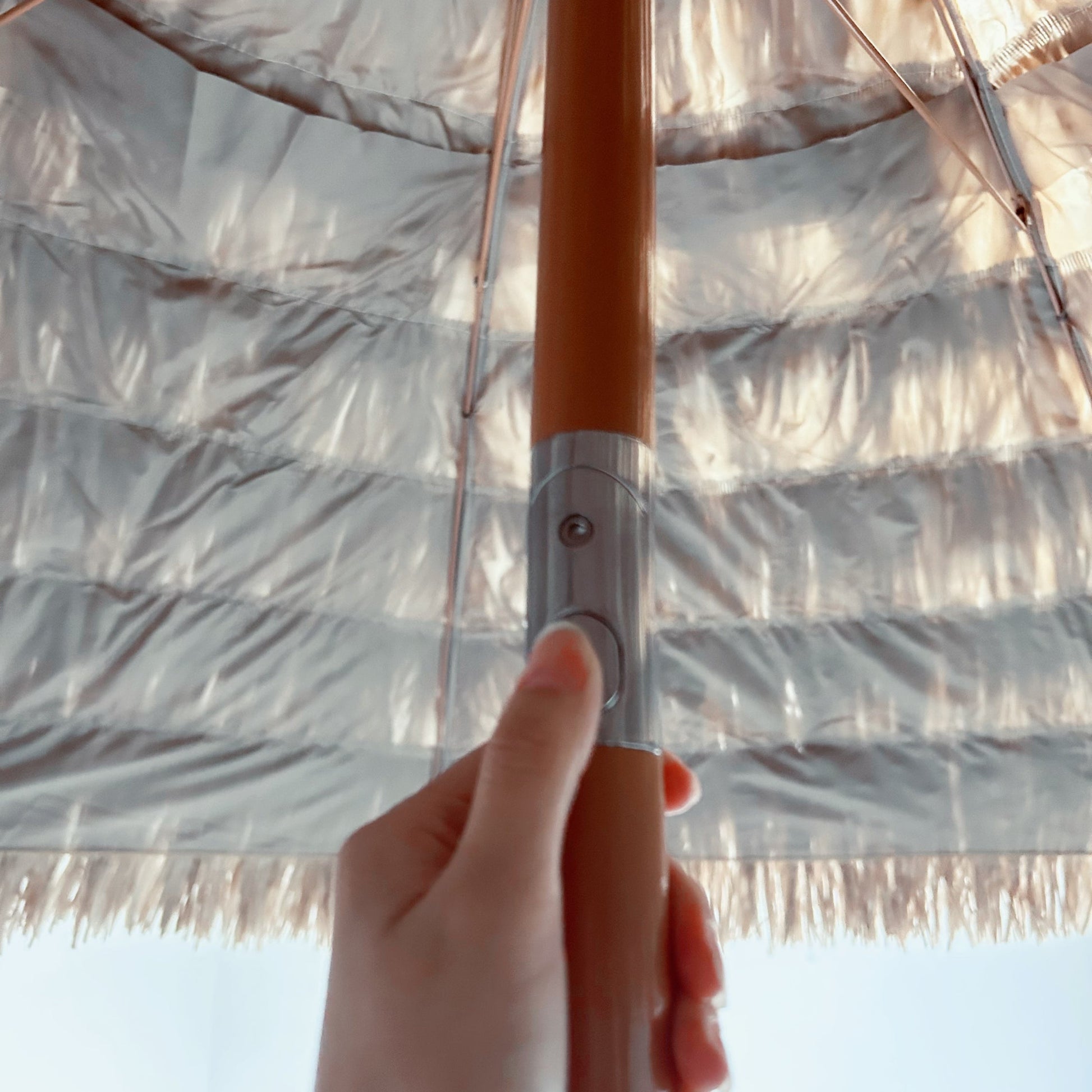 Hand holding an umbrella with a clear background