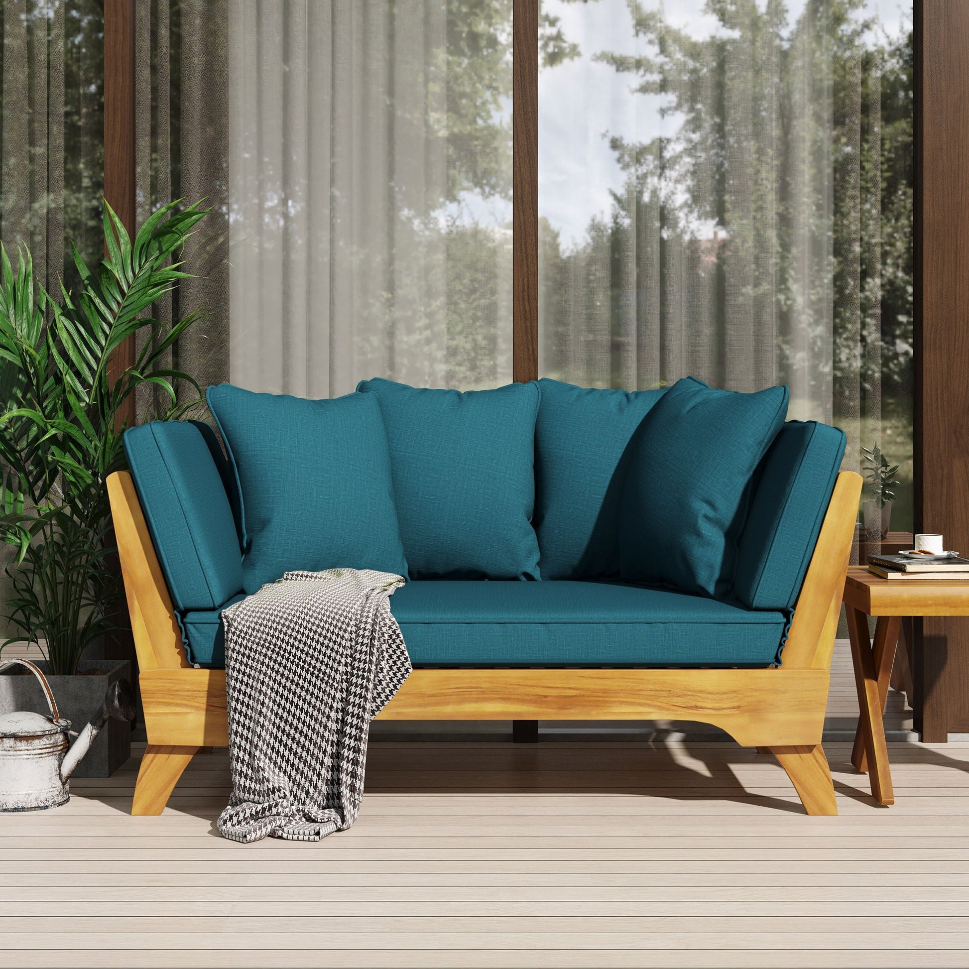 Teal cushioned outdoor sofa with wooden frame on a patio