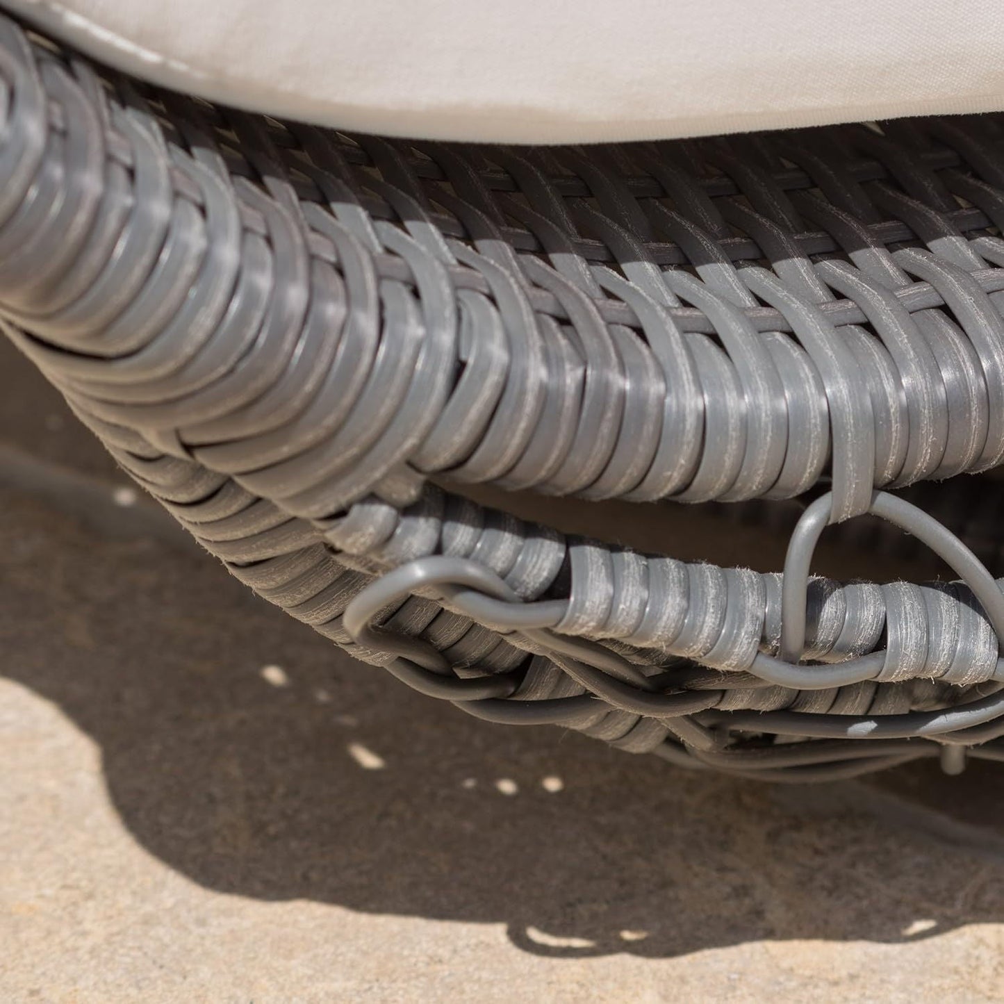 Close-up of a coiled gray hose on a textured surface
