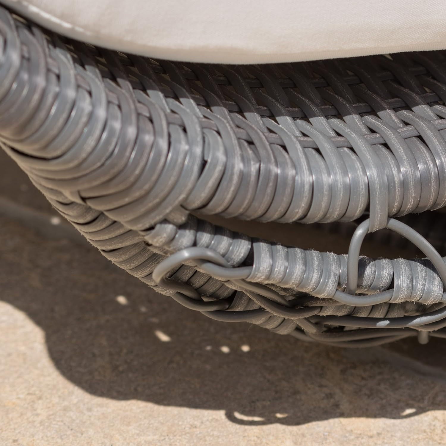 Close-up of a coiled gray hose on a textured surface