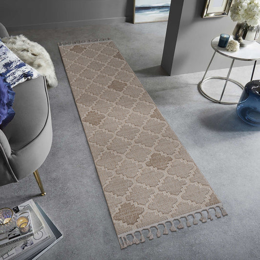 Long rectangular rug with a geometric pattern on a gray floor in a living room setting.