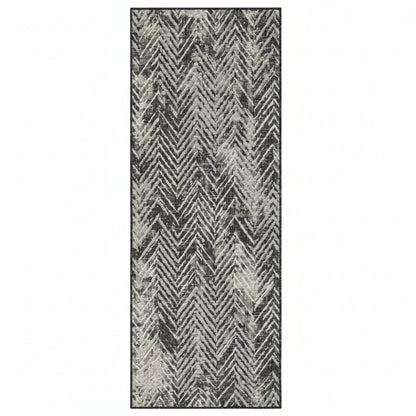 Patterned rug with zigzag design in black and gray on a white background