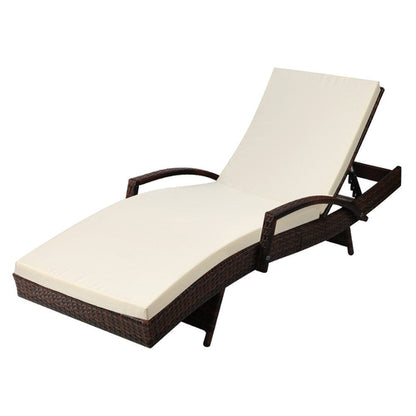 Brown wicker sun lounger with beige cushion on a white background
