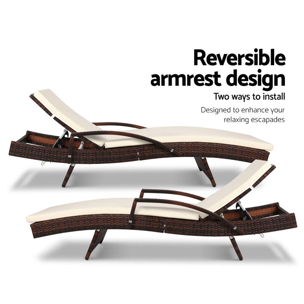Two wicker lounge chairs with reversible armrest design on a white background.