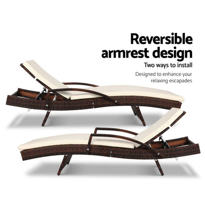 Two wicker lounge chairs with reversible armrest design on a white background.