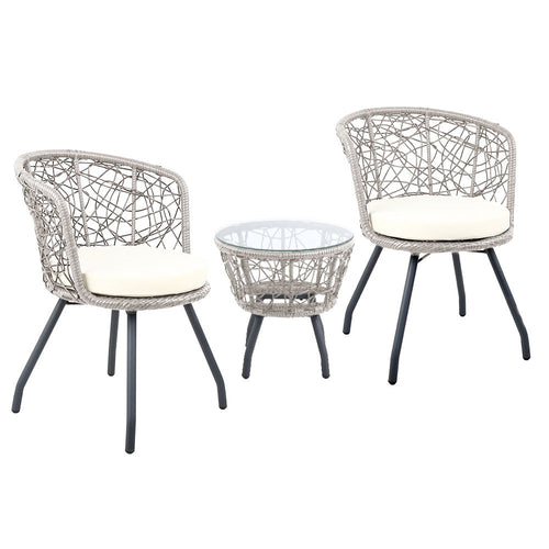 Two wicker chairs with white cushions and a matching table on a white background