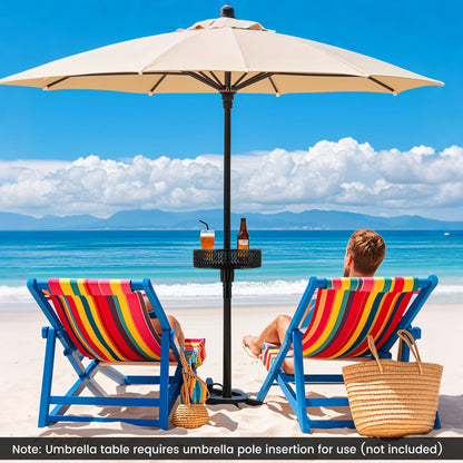 Two people sitting on colorful beach chairs under a large beige umbrella with a view of the ocean.