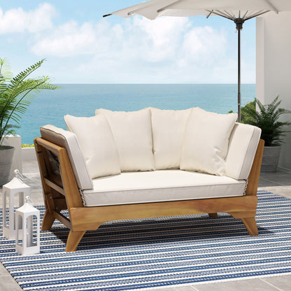 Outdoor sofa with white cushions on a patio with ocean view