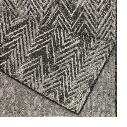 Textured rug with a geometric pattern on a plain background