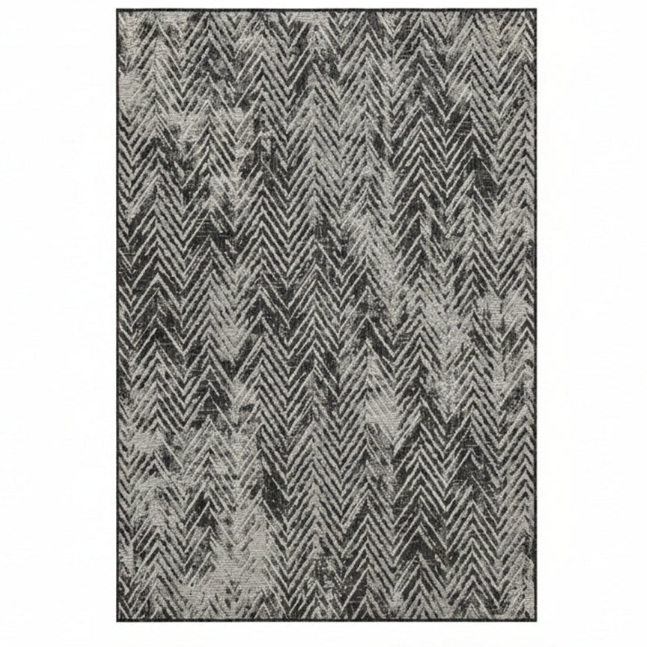 Patterned rug with zigzag design in black and gray on a white background