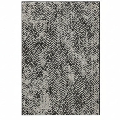 Patterned rug with zigzag design in black and gray on a white background