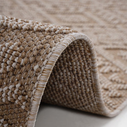 Close-up of a textured beige and brown rug corner.