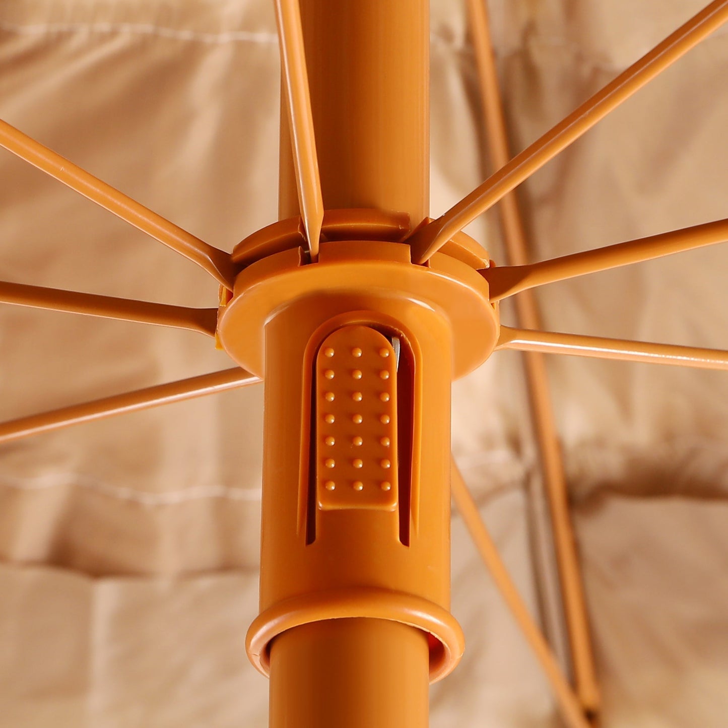 Close-up of an orange umbrella with a blurred background