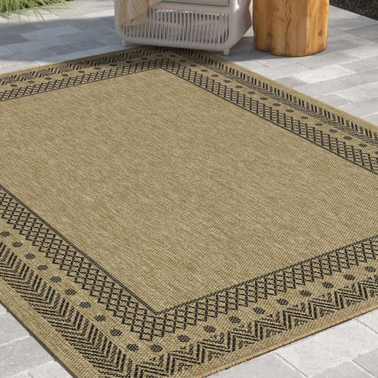 Beige outdoor rug with black pattern on a patio