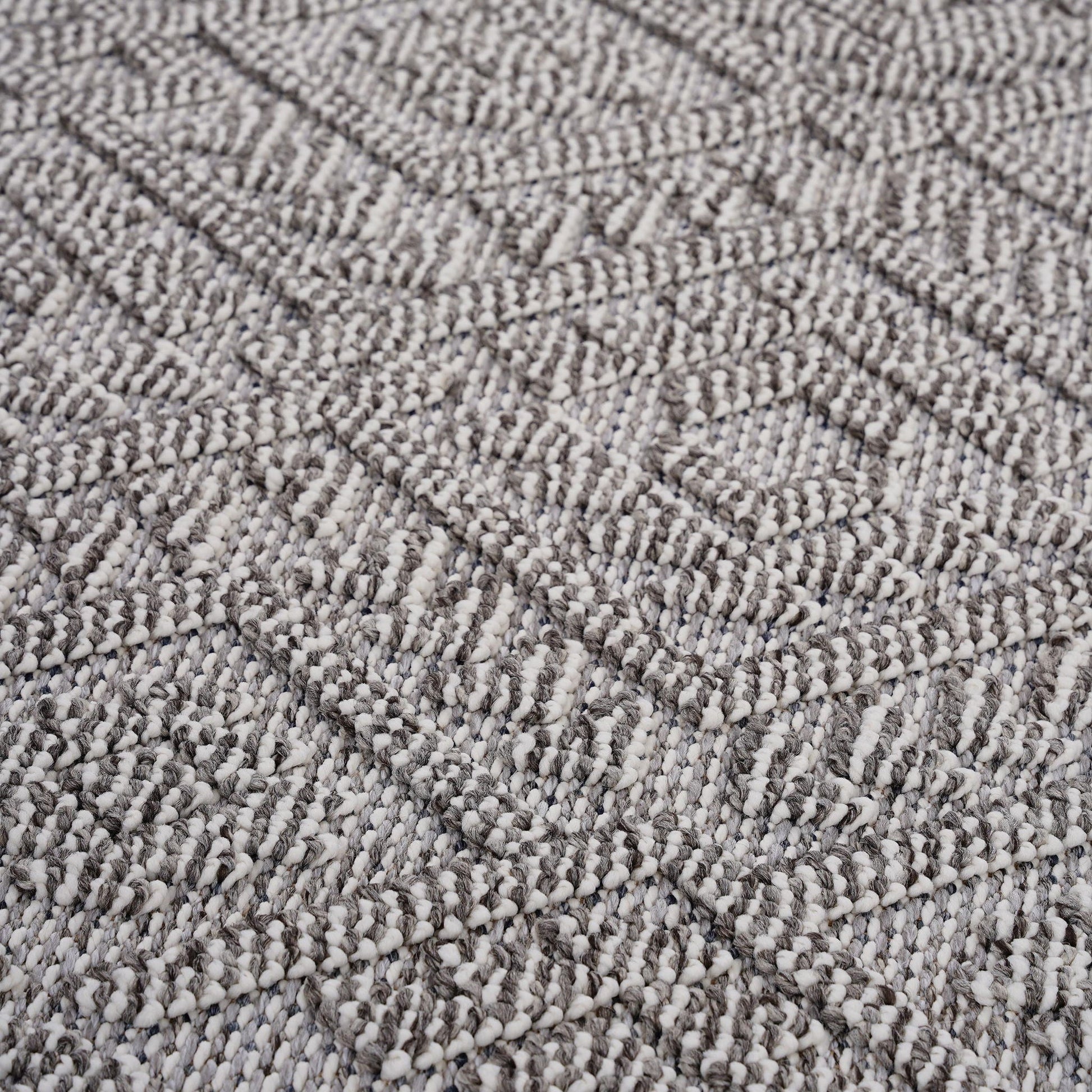 Close-up of textured gray carpet with a diamond pattern