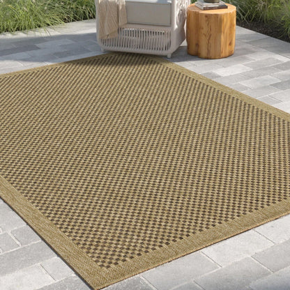 Brown outdoor rug on a patio with a chair and table in the background