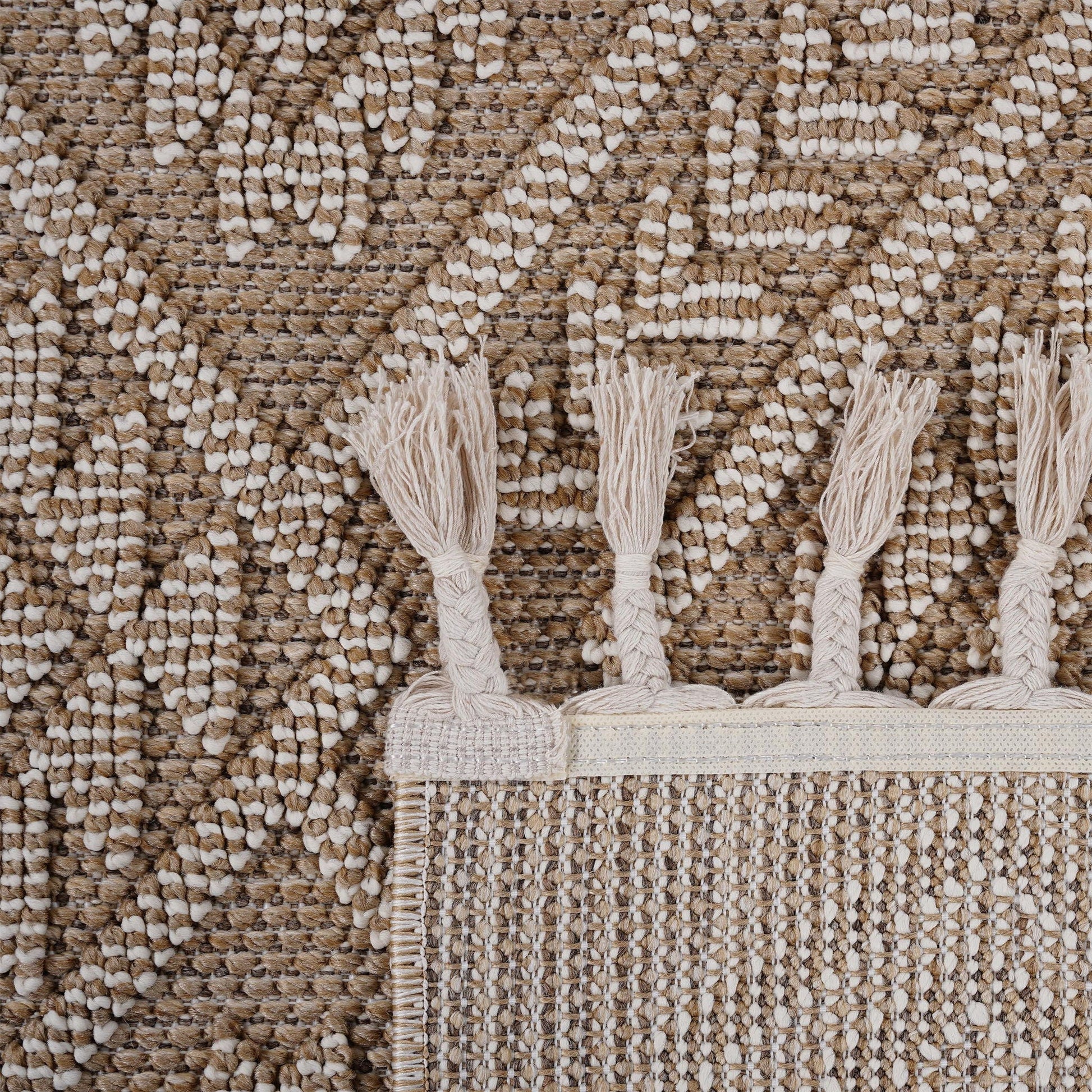 Close-up of a textured rug with tassels on a matching background