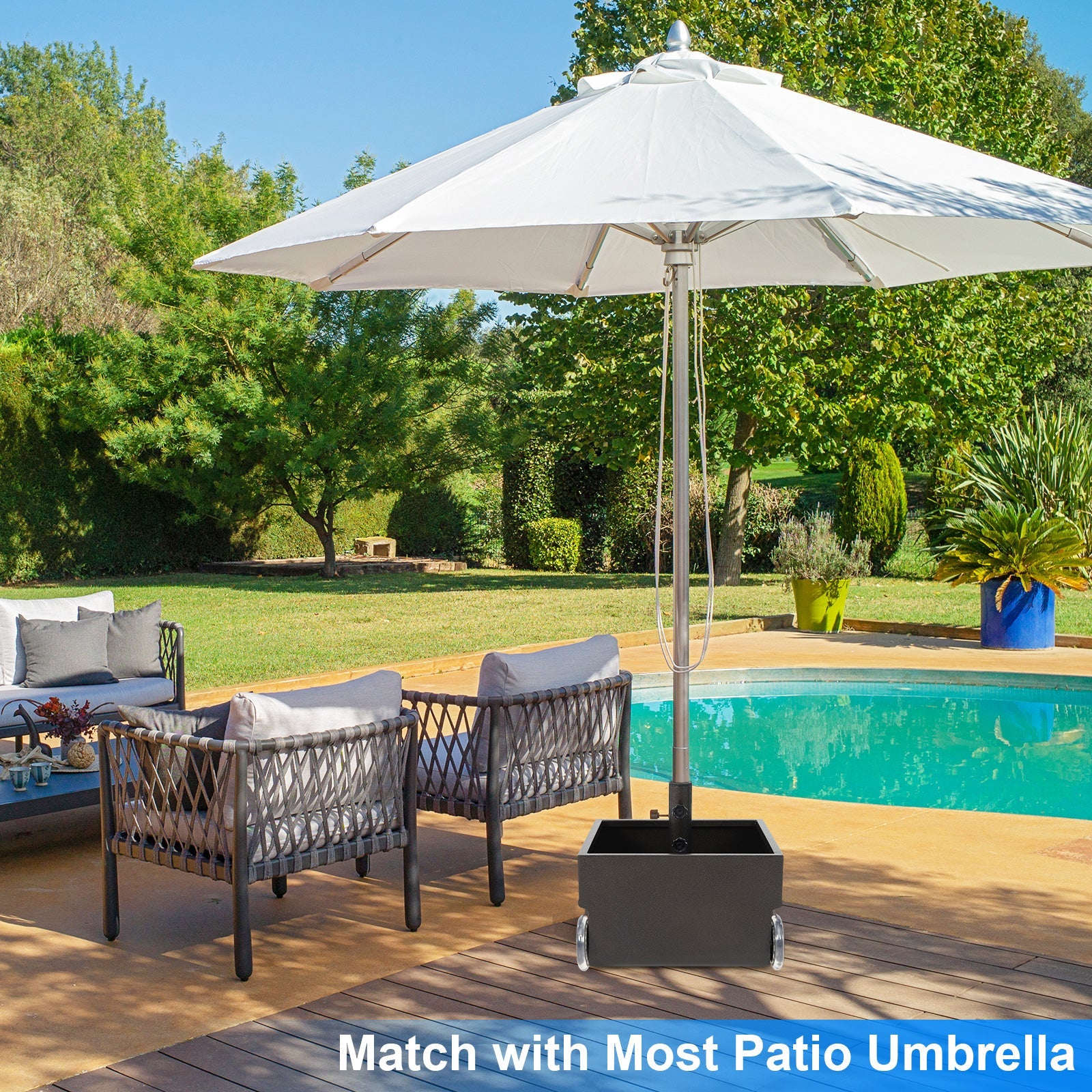 Outdoor patio set with chairs and a large umbrella by a pool