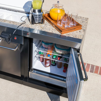 Outdoor kitchen counter with a refrigerator, drinks, and a blender.