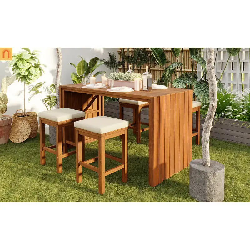 Wooden outdoor dining set with stools and cushions in a garden setting.