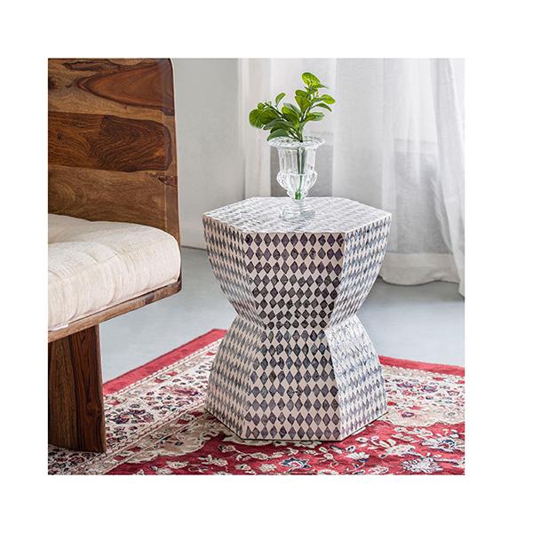 Decorative side table with geometric pattern in a room setting