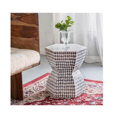 Decorative side table with geometric pattern in a room setting