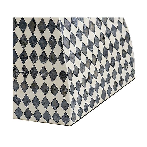 Hexagonal marble coaster with black and white diamond pattern on a white background